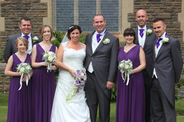 Bride and groom their bridesmaids and groomsmen outside the church after the ceremony | Purple themed wedding| Rhiannon & Michael's Real Wedding | Confetti.co.uk