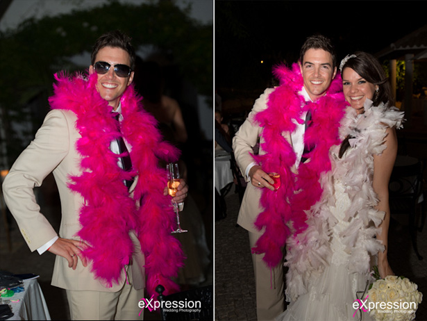 Bride and groom enjoying their wedding reception wearing pink feather boas  | Sheraton Algarve Hotel, in the Algarve, Portugal| Debora and James’s real destination wedding | Confetti.co.uk