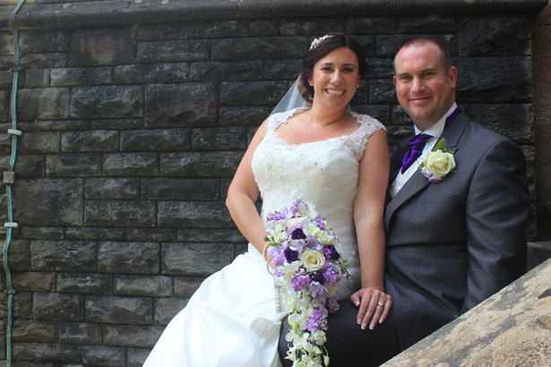 Bride and groom on the staircase outside the church | Purple themed wedding| Rhiannon & Michael's Real Wedding | Confetti.co.uk