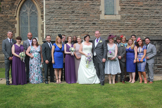 Bride and groom with their wedding guests| Purple themed wedding| Rhiannon & Michael's Real Wedding | Confetti.co.uk