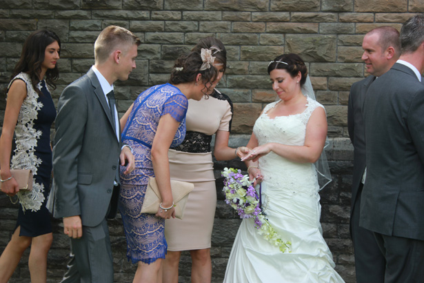 Bride showing her female wedding guest her wedding ring| Purple themed wedding| Rhiannon & Michael's Real Wedding | Confetti.co.uk