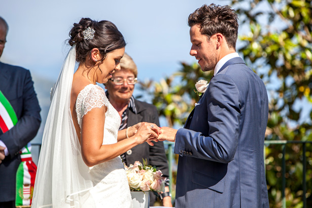 The bride and groom exchanging wedding rings | Outside wedding ceremony ideas | Leanne and Chris's Real Italian Wedding | Confetti.co.uk 