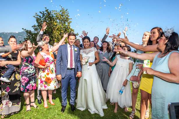 Wedding guests throwing confetti to celebrating the marriage | Outside wedding ceremony ideas | Leanne and Chris's Real Italian Wedding | Confetti.co.uk