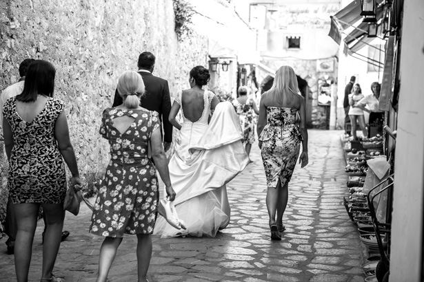 Bride and the wedding guests walking through the streets of Ravello to the wedding reception | Funny wedding moments | Leanne and Chris's Real Italian Wedding | Confetti.co.uk