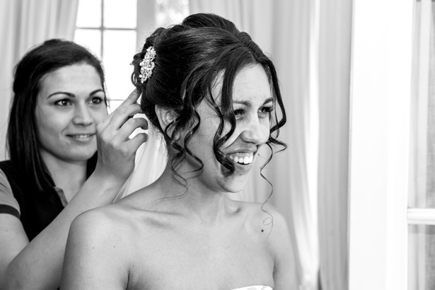 Hair stylist adding diamante clip to the brides hair | Leanne and Chris's Real Italian Wedding | Confetti.co.uk