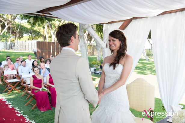 Bride and groom at holding hands |Wedding ceremony at the Sheraton Algarve Hotel, in the Algarve, Portugal.| Debora and James’s real destination wedding | Confetti.co.uk