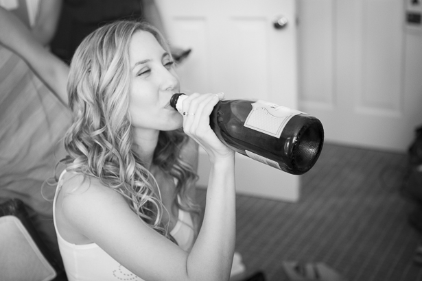 Bride drinking champagne from the bottle as she gets ready | Crystal & Giampaolo California Real Wedding |Destination Wedding America | Confetti.co.uk 