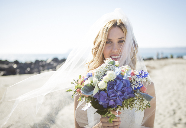 Bride on the California beach holding her rustic wedding bouquet | Crystal & Giampaolo California Real Wedding |Destination Wedding America | Confetti.co.uk 