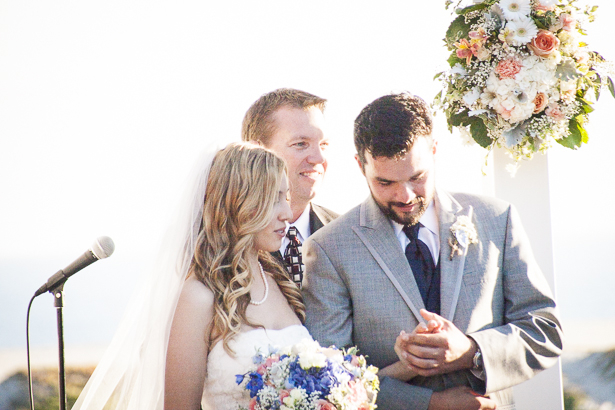 The groom looking and his new wife’s wedding ring | Outdoor wedding ceremony ideas | Beach wedding | Crystal & Giampaolo California Real Wedding |Destination Wedding America | Confetti.co.uk 