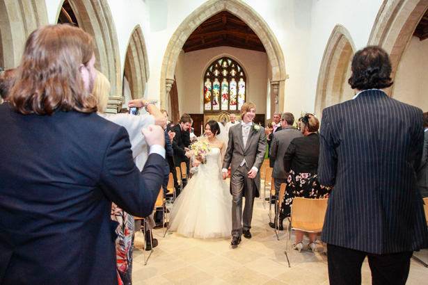 The bride and the groom leaving the church as newlweds|Wedding ceremony at St Marys Church, Bletchley | Shasha and James real wedding | 1920’s Great Gatsby Wedding Confetti.co.uk 