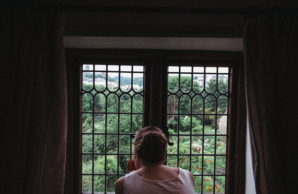 The bride looking out the window in to the garden| Steph and Gary's Real Garden Wedding | Confetti.co.uk 