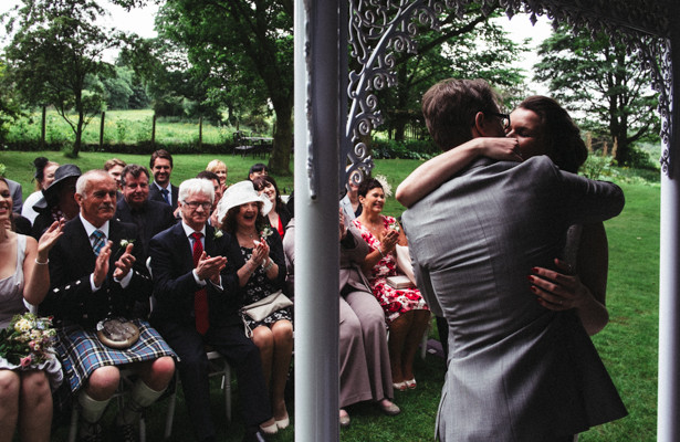 The bride and grooms first kiss as husband and wife | Garden wedding ideas | Steph and Gary's Real Garden Wedding | Confetti.co.uk 