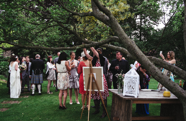 Wedding guests enjoying refreshments in the garden| Garden wedding ideas | Steph and Gary's Real Garden Wedding | Confetti.co.uk 