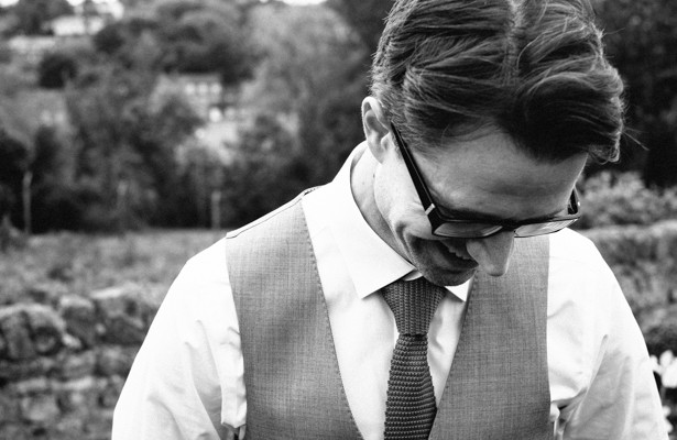 Groom in a grey waist coat and red tie | Steph and Gary's Real Garden Wedding | Confetti.co.uk 