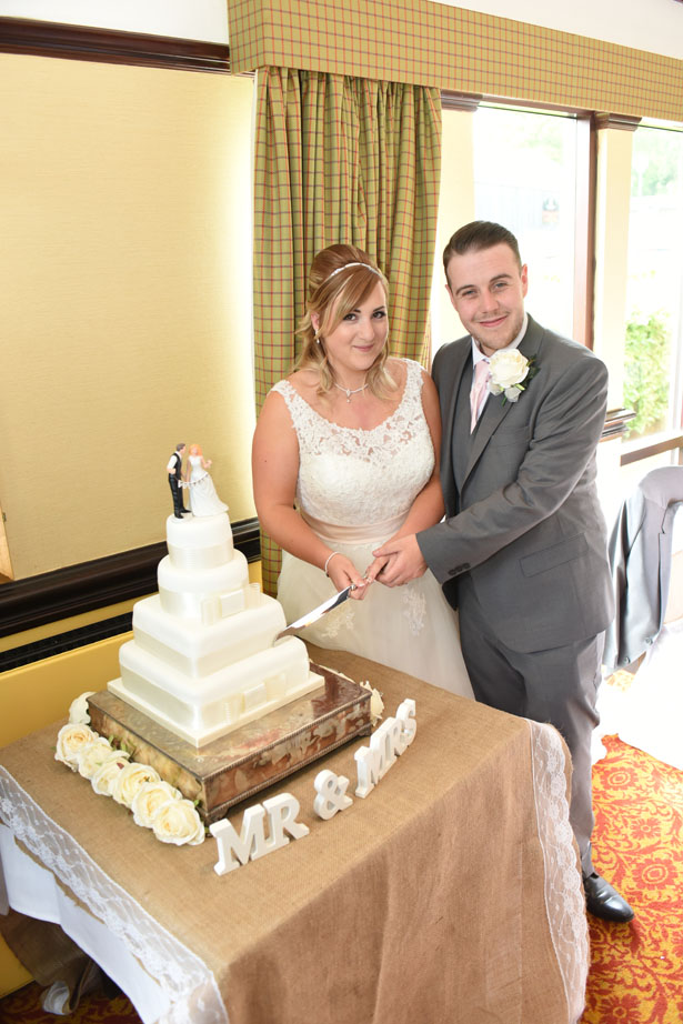 Laura & Daniel slice their wedding cake from Waitrose. Cake topper courtesy of Confetti.co.uk