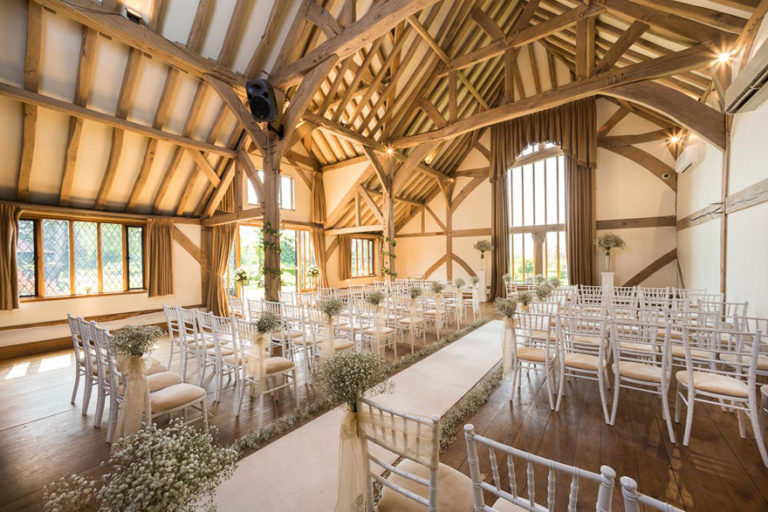 The Music Room Set Up For a Wedding Ceremony at Cain Manor in Surrey - Bijou Wedding Venues - Barn Style Country House Wedding Venue with Baby's Breath Wedding Aisle | Confetti.co.uk