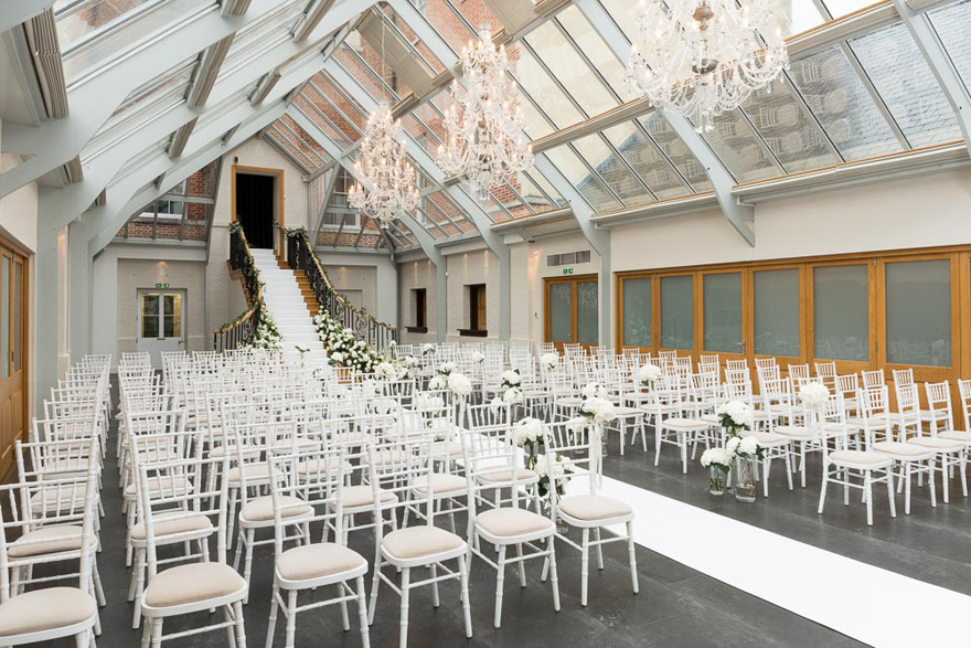 Wedding Ceremony in The Atrium at Botleys Mansion in Surrey - Bijou Wedding Venues - Elegant Country House Wedding - Wedding Ceremony with Steps - Weding Aisle with Stairs | Confetti.co.uk