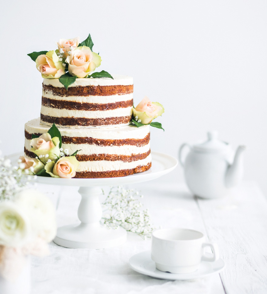 Modest Naked Wedding Cake - Rustic Wedding Cake with Flowers by Melnikov Sergey on Shutterstock | Confetti.co.uk