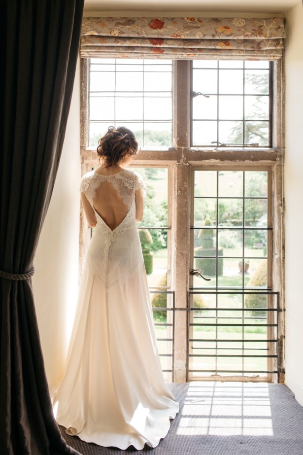 Askham Hall bride at picture window | Confetti.co.uk