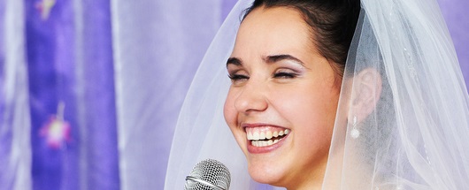 Bride holding a microphone, making a bride's speech