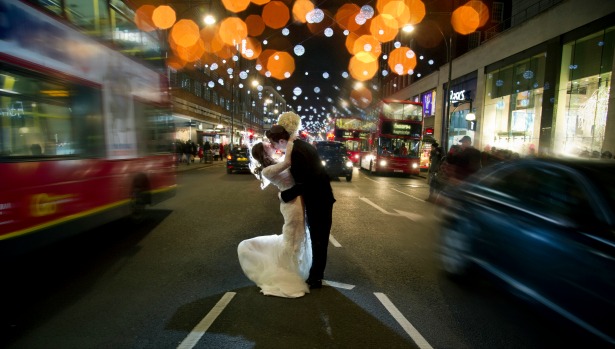 Bride and groom kissing in city traffic by Halo and Hobby at Fabulous Wedding Photography | Confetti.co.uk