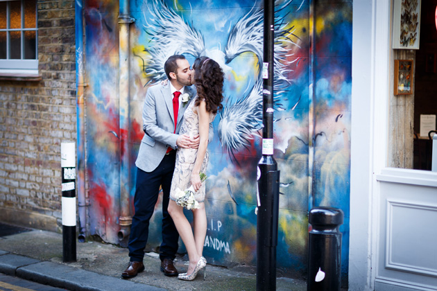 Bride and groom in front of street art at Veronica and Alejandro's real wedding| Confetti.co.uk