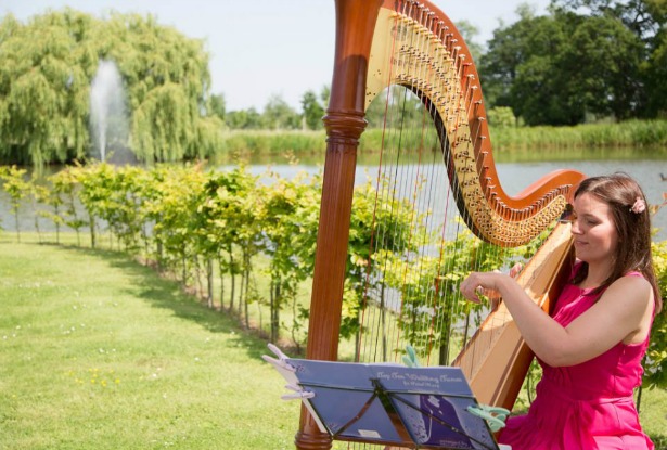 Warble Entertainment harpist playing outside | Confetti.co.uk