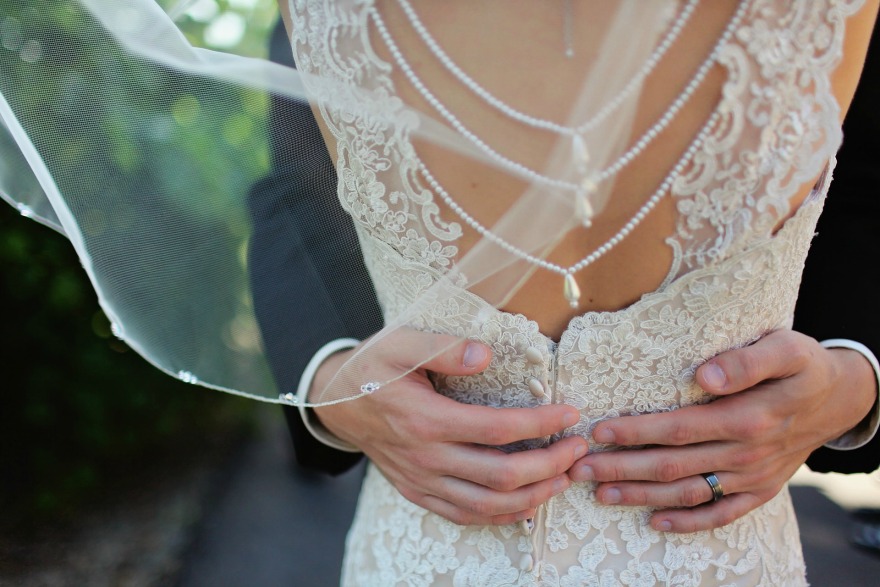 Bride and groom lace and pearl detail dress back | Confetti.co.uk