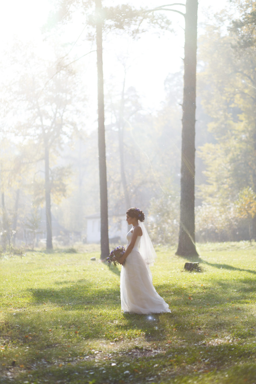 Sun rays beating down on woman walking in forest | Confetti.co.uk