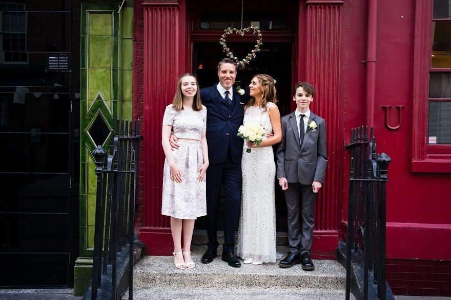 Bride & Groom with their children outside Soho city wedding venue | Confetti.co.uk