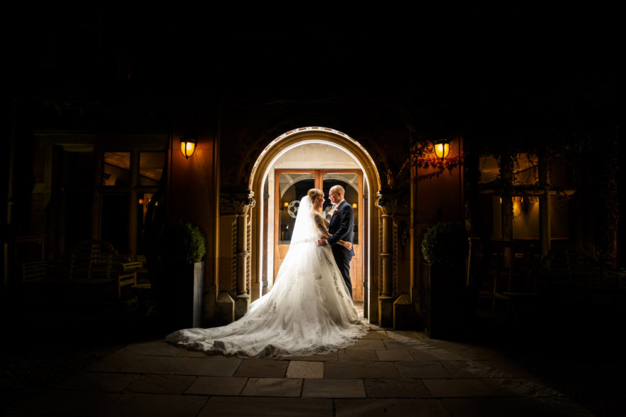 Bride and Groom in doorway at Soughton Hall | Confetti.co.uk