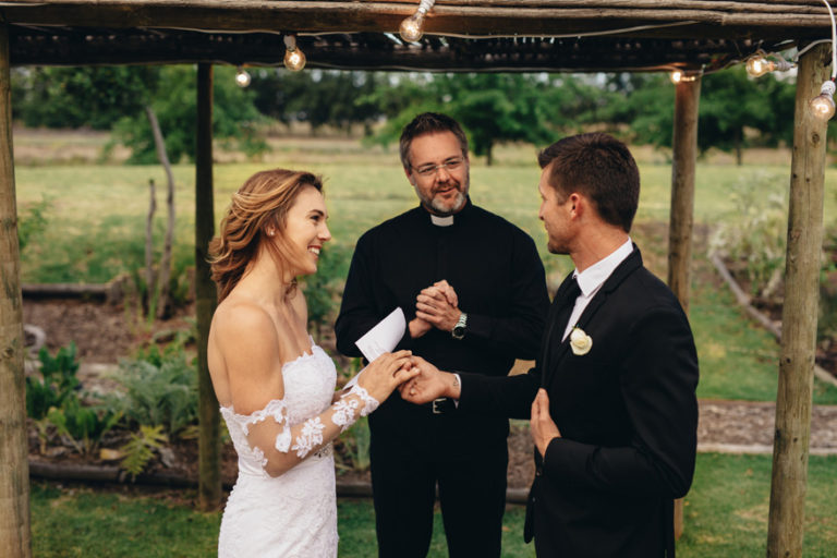 Bride and Groom Exchanging Wedding Vows in Front of Priest - Bride's Speech - Bride's Vows | Confetti.co.uk