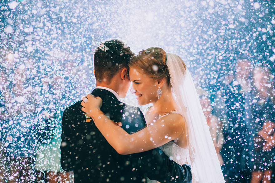 Bride and Groom in Falling Snow Confetti Shower | Confetti.co.uk