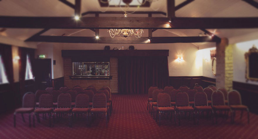 Pennine Manor Branston Suite Burgundy Wedding Reception with Rustic Wooden Beams and Chandelier | Confetti.co.uk