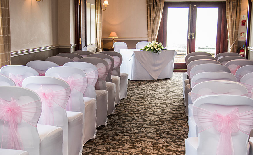 Pennine Manor Hilltop Wedding Ceremony Room with Pink and White Chair Decor | Confetti.co.uk