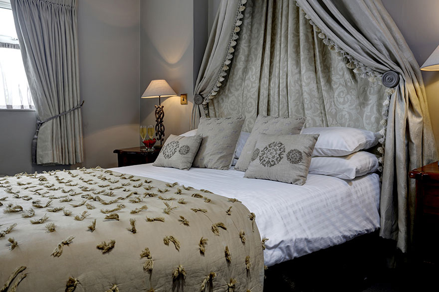 Pennine Manor Wedding Bedroom with Drapes and Champagne | Confetti.co.uk