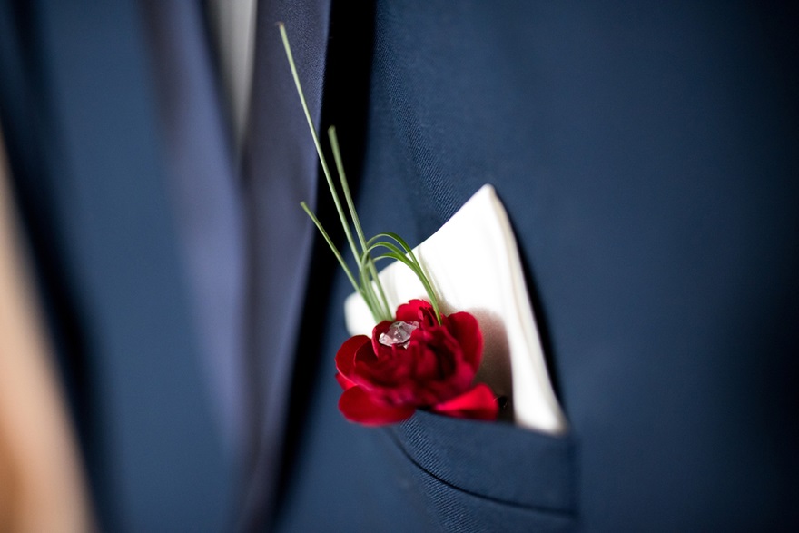 Red flower and handkerchief buttonholes | Confetti.co.uk