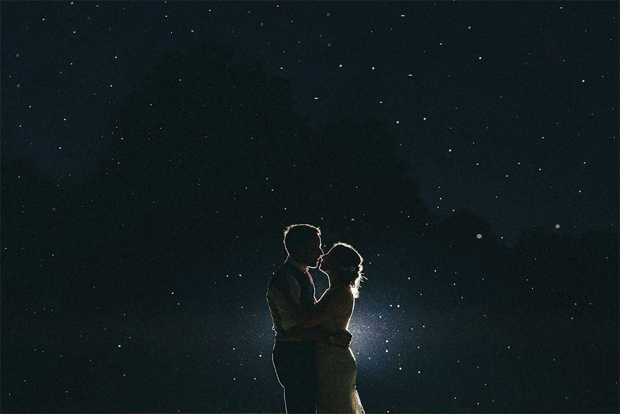 Couple Embracing Under the Stars - Husband and Wife Starry Sky - Rachele and Luke’s Outdoor Country Garden Wedding in Norfolk by Miki Photography | Confetti.co.uk