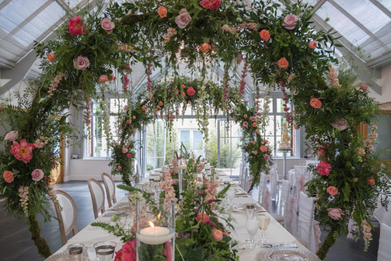 Interesting Wedding Reception Decor - Creative Wedding Decor - Floral Hoops - Floral Arches Over the Wedding Reception Table with Hanging Flowers | Confetti.co.uk