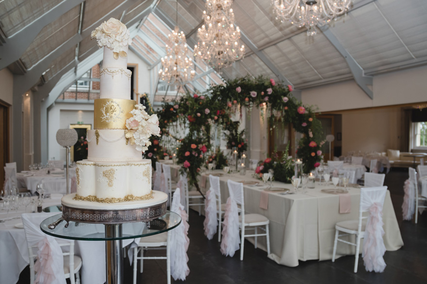 Lavish White and Gold Cake by Unique Cakes by Yevnig - Ornate Tiered Wedding Cake at Botley's Manor Wedding Reception | Confetti.co.uk