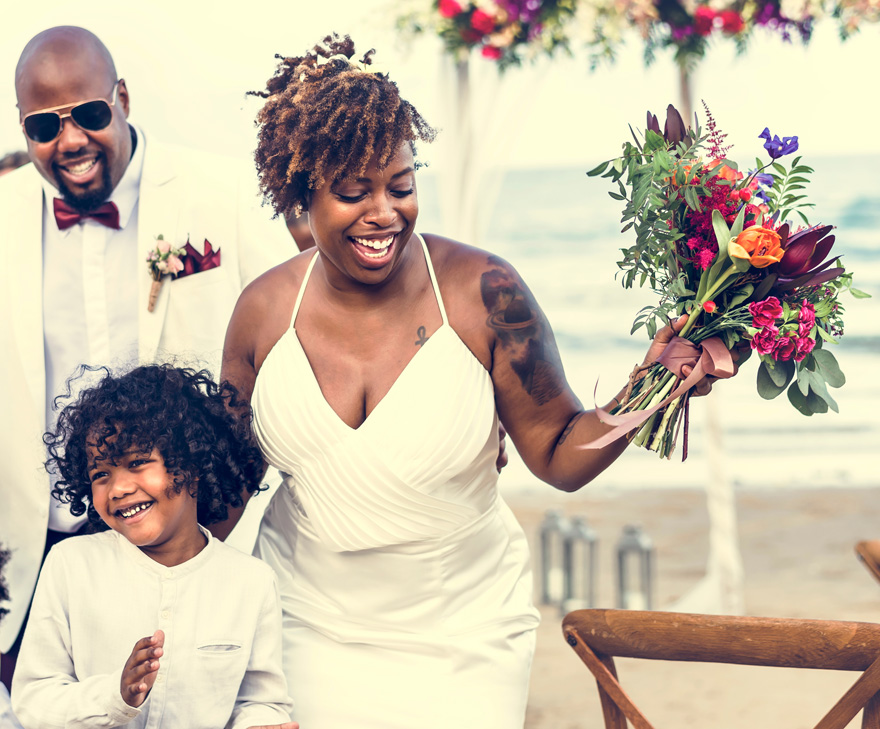 Black Bride with Tattoo - Colourful Beach Wedding - Brides with Tattoos - Happy Bride and Groom in a Wedding Ceremony at a Tropical Island by Rawpixel on Shutterstock | Confetti.co.uk