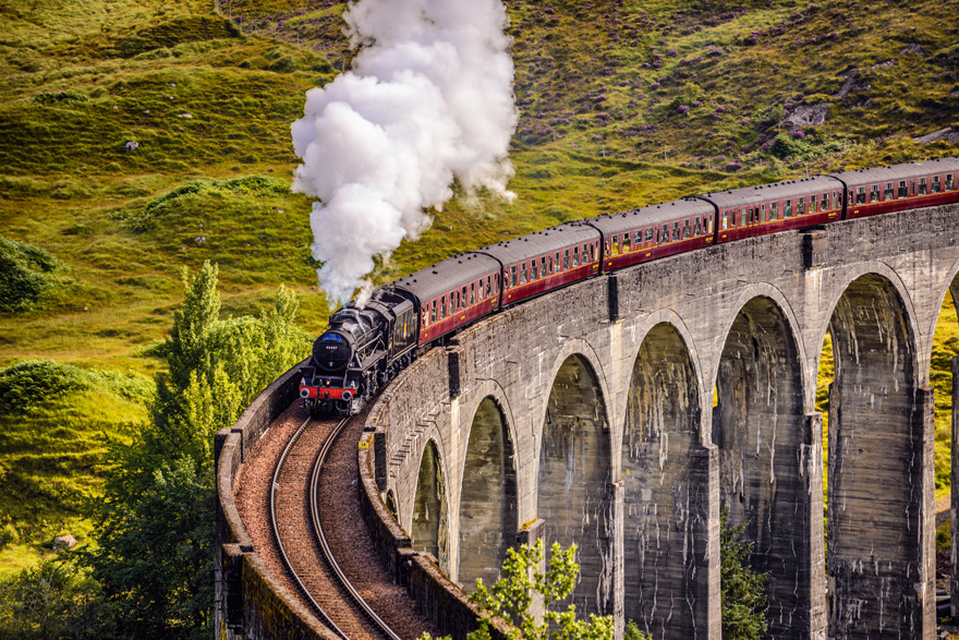 Glenfinnan Railway Viaduct in Scotland with the Jacobite Steam Train Passing Over by Nick Fox on Shutterstock - Hogwarts Express Harry Potter Wedding Ideas | Confetti.co.uk