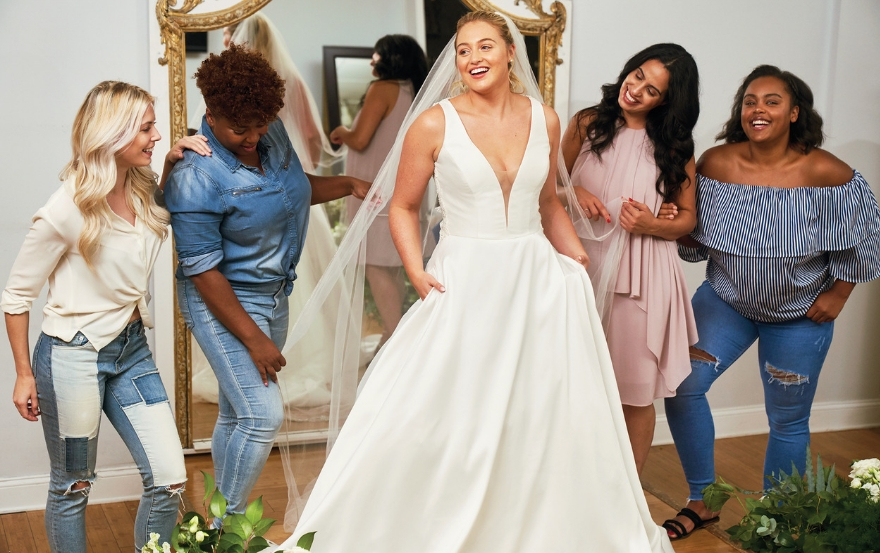 Bride trying on Justin Alexander wedding dress