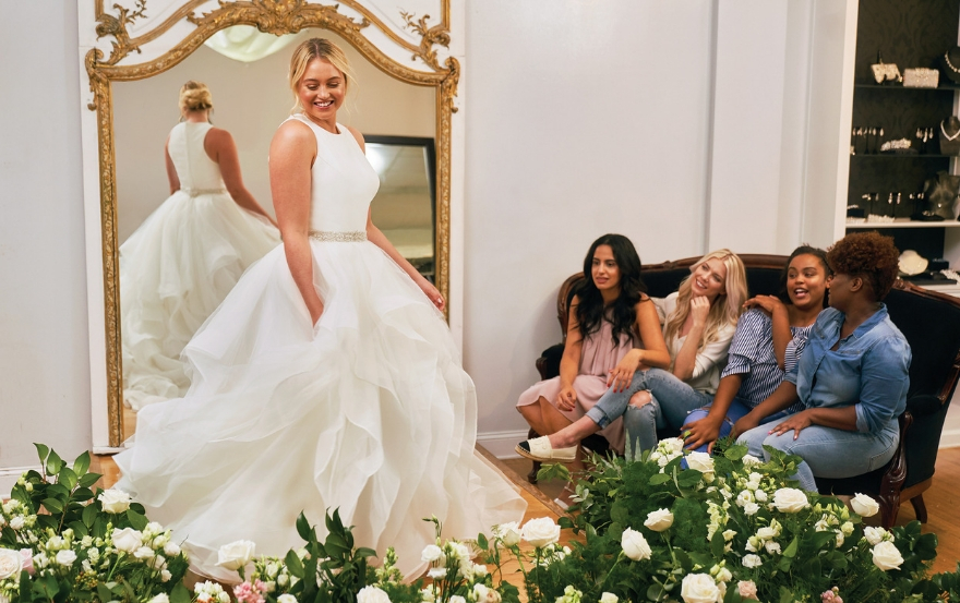 Bride trying on full-skirted Justin Alexander dress